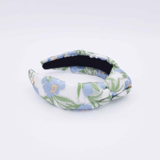 Knotted white headband with blue floral print and black lining. Featured Product: Josephine Knot Headband, SKU: HB-437DB-045-RG